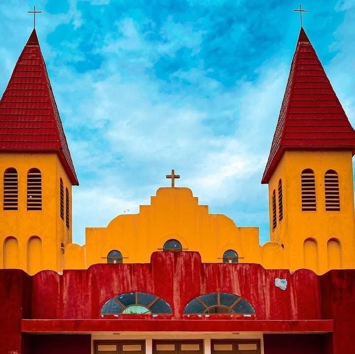 Façade de la cathédrale Christ-Roi de Daloa, ses deux clochers rouges et la croix centrale